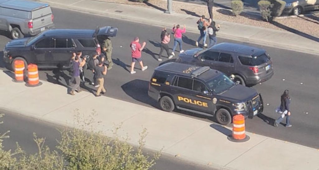 People leave campus with raised hands after UNLV Campus Shooting